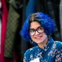 A student smiling with other guests.